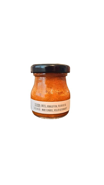 Rückseite der Flame Fusion Chilipaste – Zutatenliste und Anwendungshinweise für die natürliche, scharfe Chilipaste, perfekt für die scharfe Küche.
